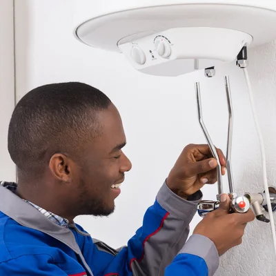 Electrician wiring a geyser thermostat control panel